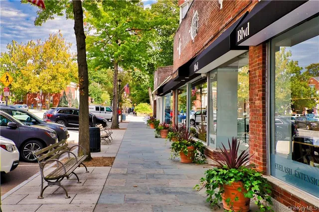a sign that is sitting in front of flowers