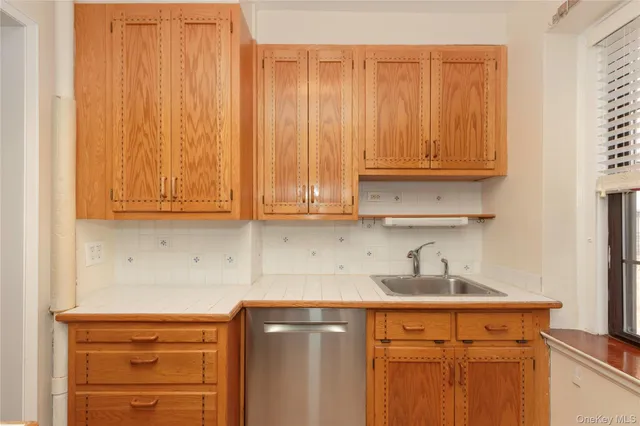 a kitchen with granite countertop wooden cabinets and white appliances