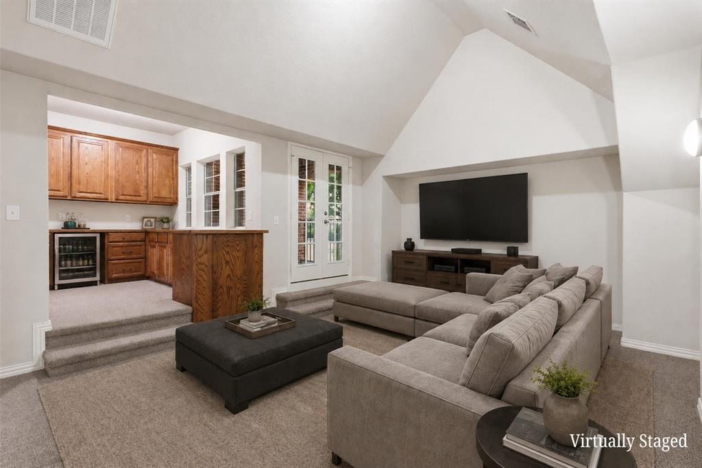 2841 Meadow Ridge Drive Prosper, TX 75078 - Photo 30 of 40 a living room with furniture and a flat screen tv