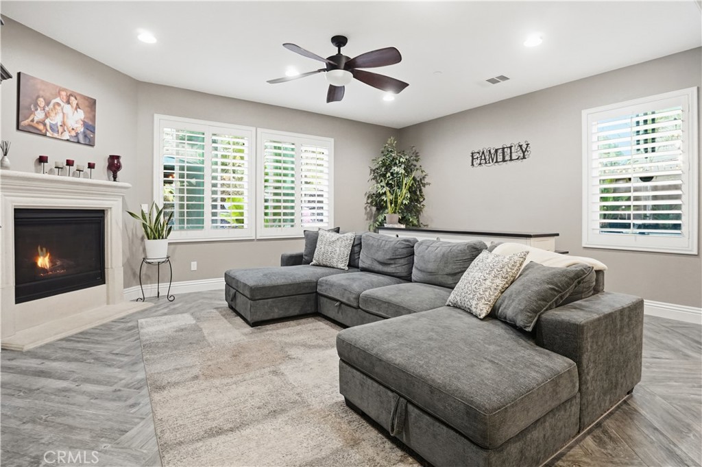 25654 Red Hawk Road Corona, CA 92883 - Photo 12 of 75 a living room with furniture a fireplace and a large window