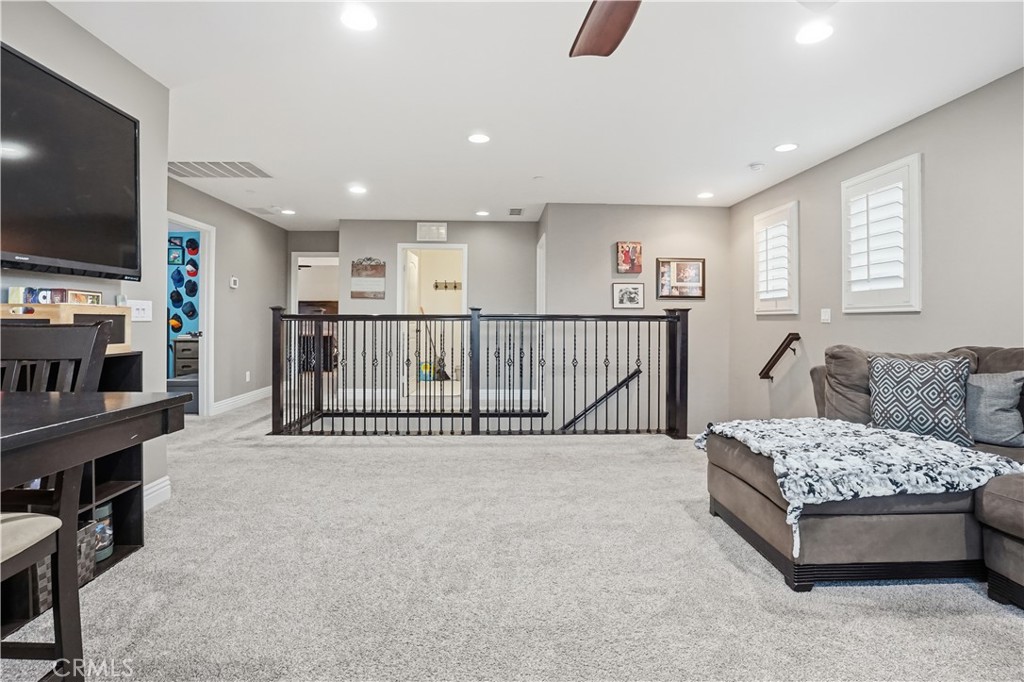 25654 Red Hawk Road Corona, CA 92883 - Photo 24 of 75 a living room with furniture and a flat screen tv
