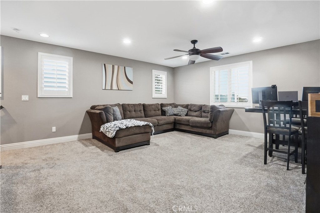 25654 Red Hawk Road Corona, CA 92883 - Photo 25 of 75 a living room with furniture and a ceiling fan