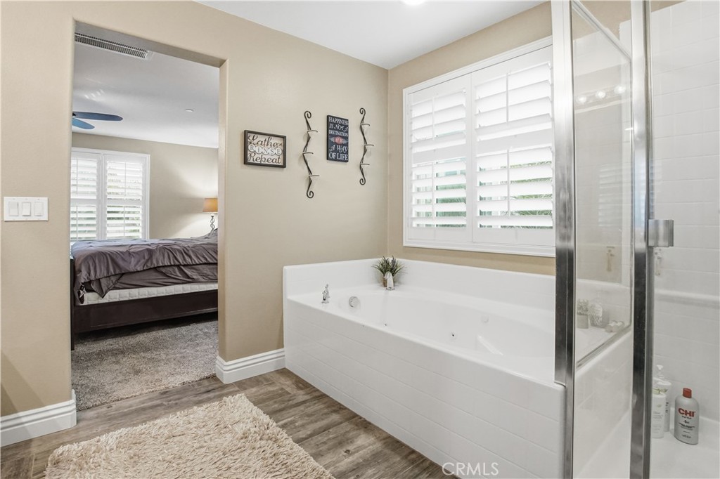 25654 Red Hawk Road Corona, CA 92883 - Photo 30 of 75 a bathroom with a tub a sink and a large mirror