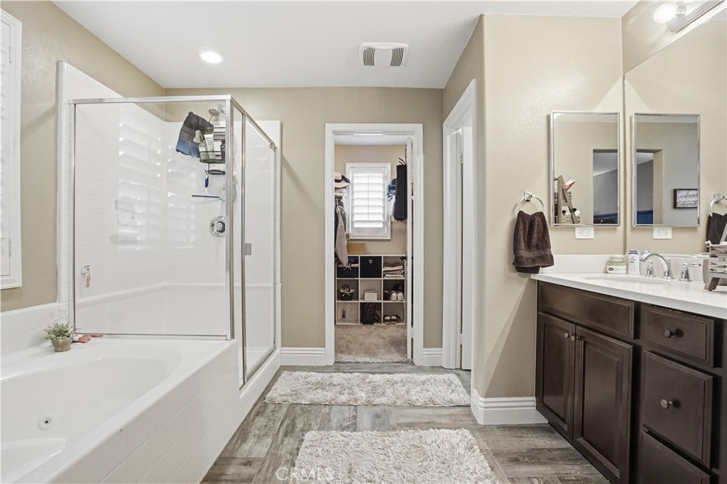 25654 Red Hawk Road Corona, CA 92883 - Photo 31 of 75 a bathroom with a tub a sink and mirrors