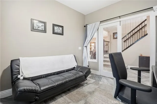 a view of a livingroom with workspace and a window