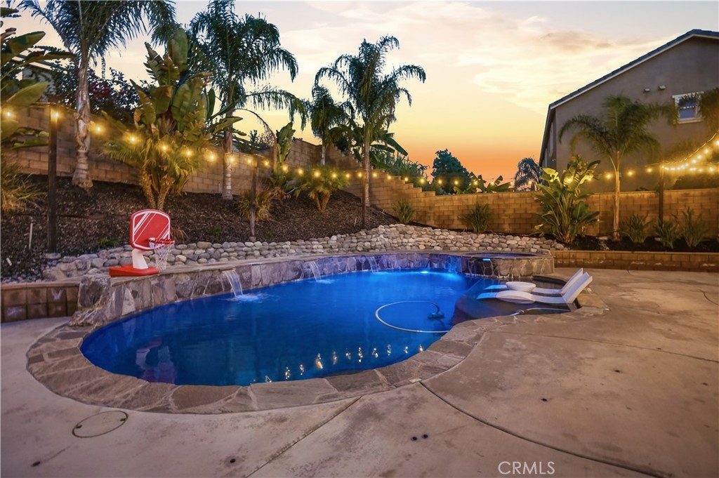 25654 Red Hawk Road Corona, CA 92883 - Photo 53 of 75 a view of a swimming pool with a table and chairs