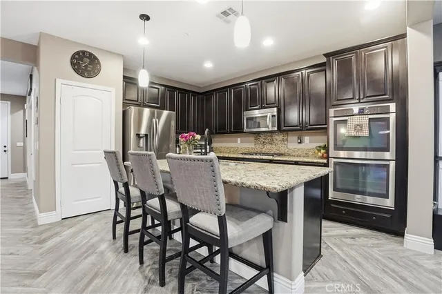 a living room with furniture a fireplace and a large window