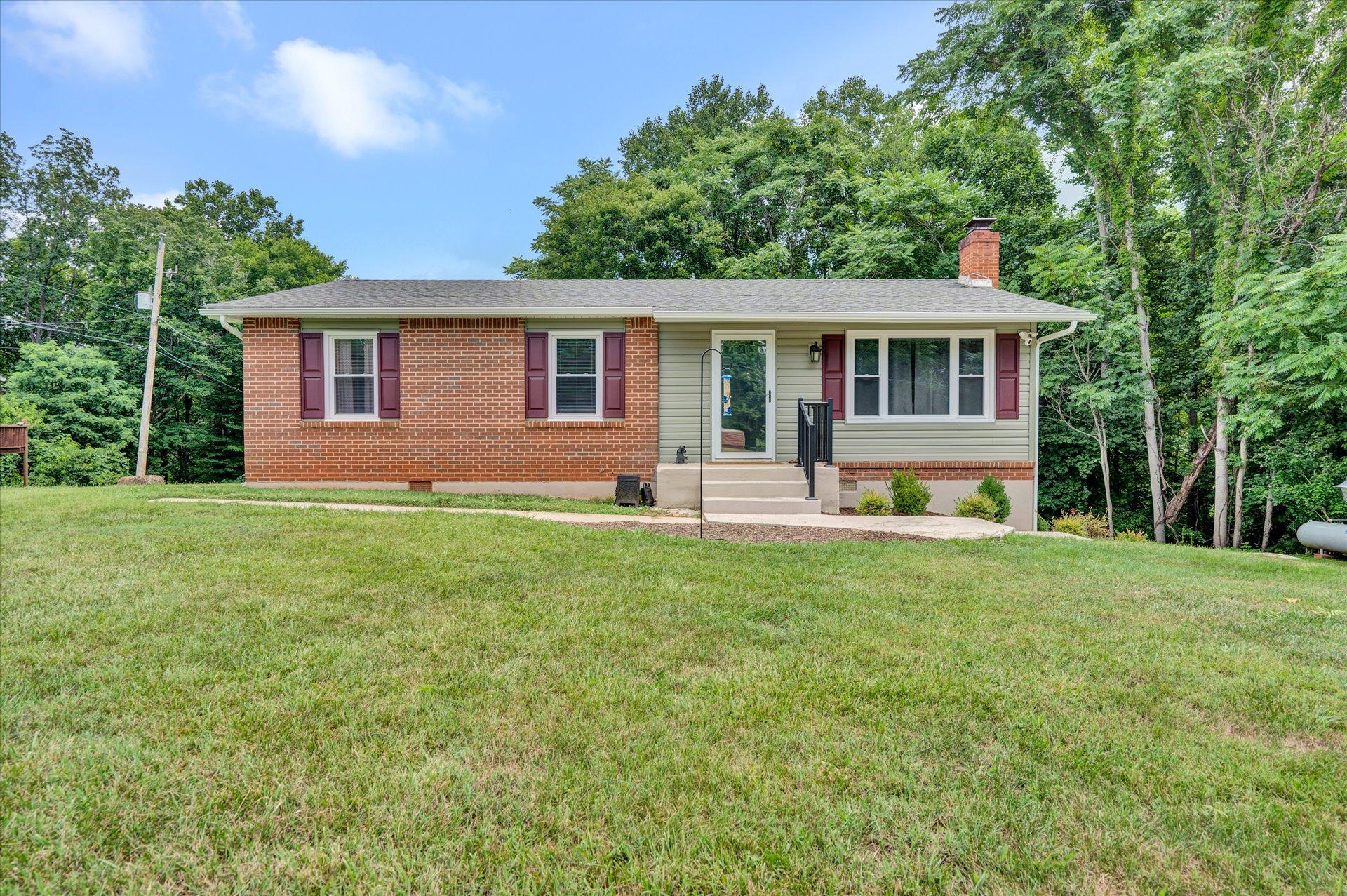 3382 Thomasson Mill Road Goodview, VA 24095 - Photo 1 of 20 a front view of house with yard and green space