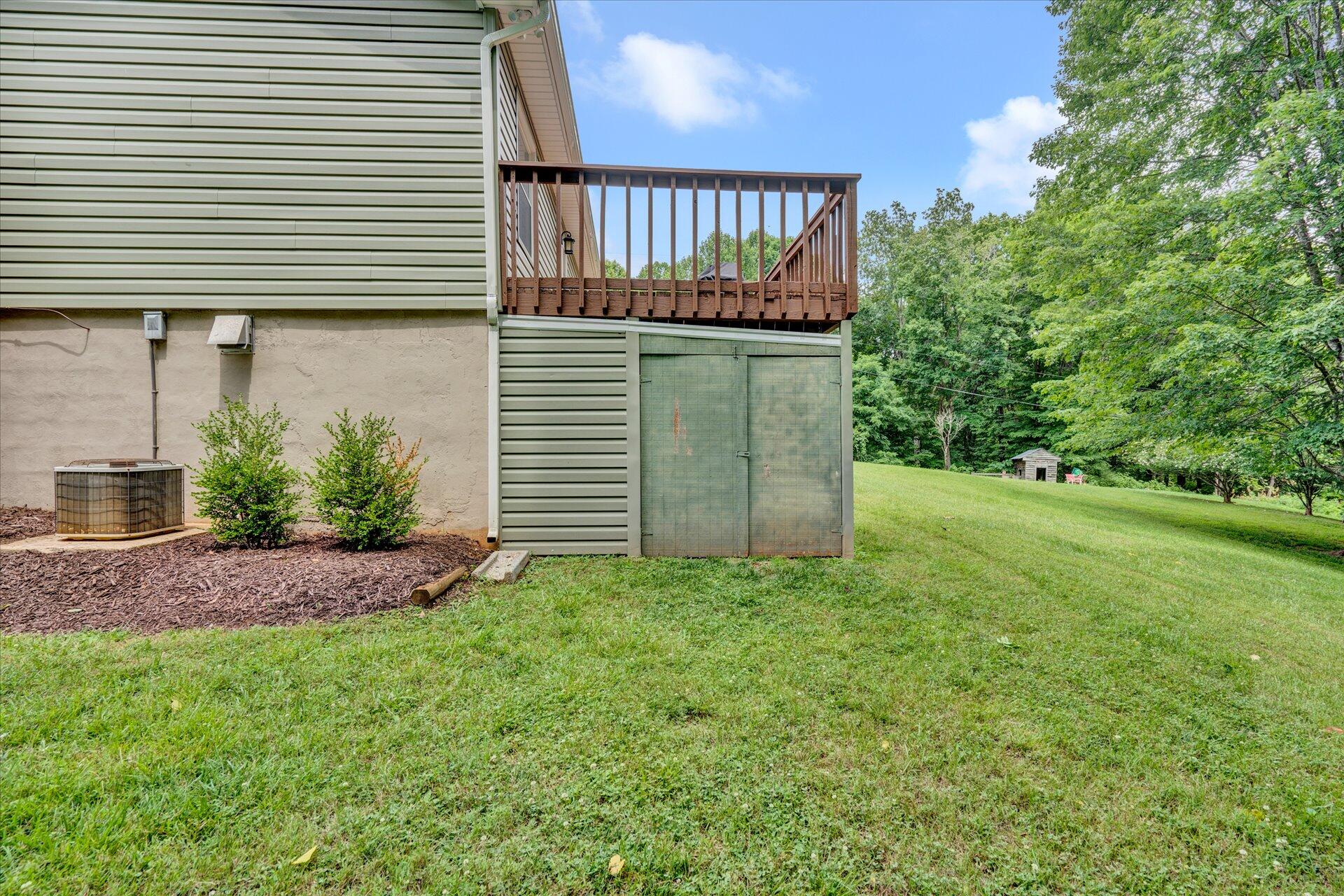 3382 Thomasson Mill Road Goodview, VA 24095 - Photo 19 of 20 a view of a house with a small yard and plants