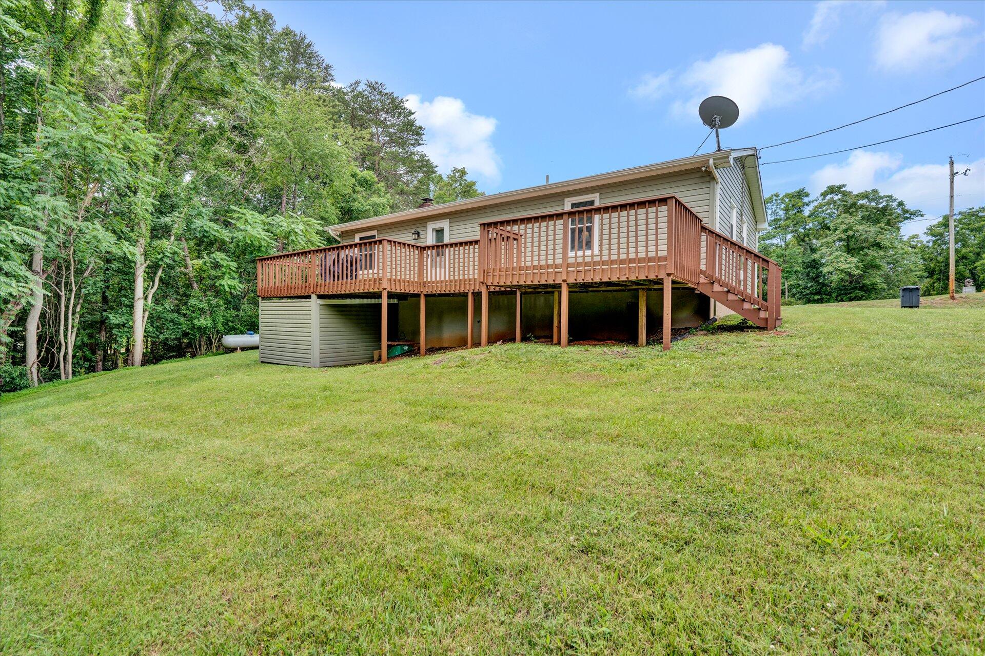 3382 Thomasson Mill Road Goodview, VA 24095 - Photo 20 of 20 a view of a house with a backyard and garden