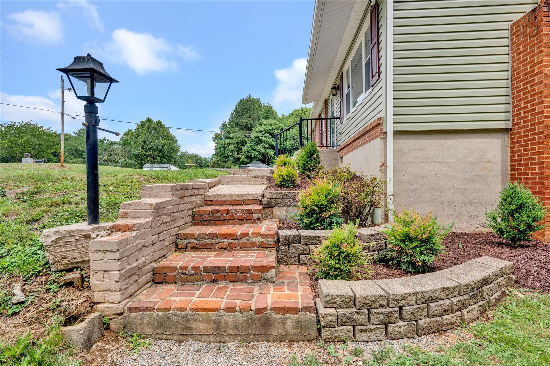 3382 Thomasson Mill Road Goodview, VA 24095 - Photo 3 of 20 a view of a porch with plants and garden