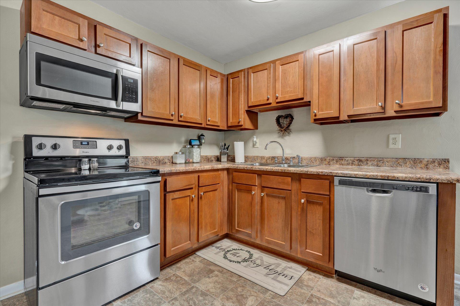3382 Thomasson Mill Road Goodview, VA 24095 - Photo 8 of 20 a kitchen with stainless steel appliances granite countertop a stove microwave and sink