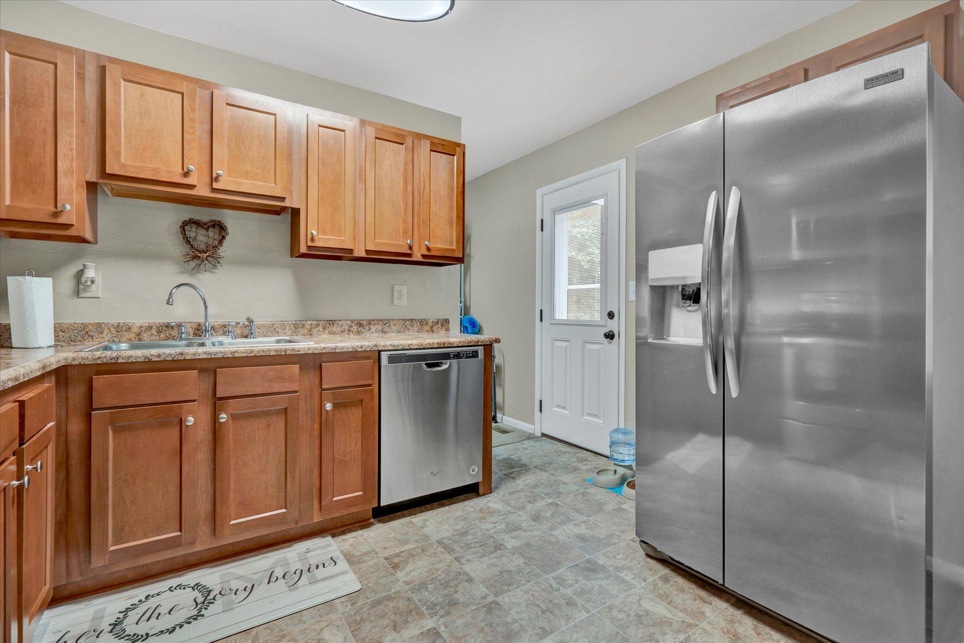 3382 Thomasson Mill Road Goodview, VA 24095 - Photo 9 of 20 a kitchen with stainless steel appliances granite countertop a refrigerator and a sink
