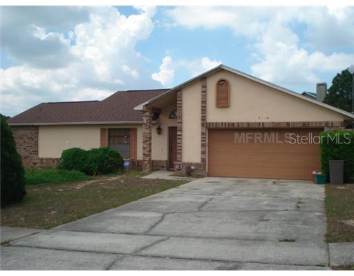 3126 Hammersmith Road Orlando, FL 32818 - Photo 1 of 1 a front view of a house with a yard and garage