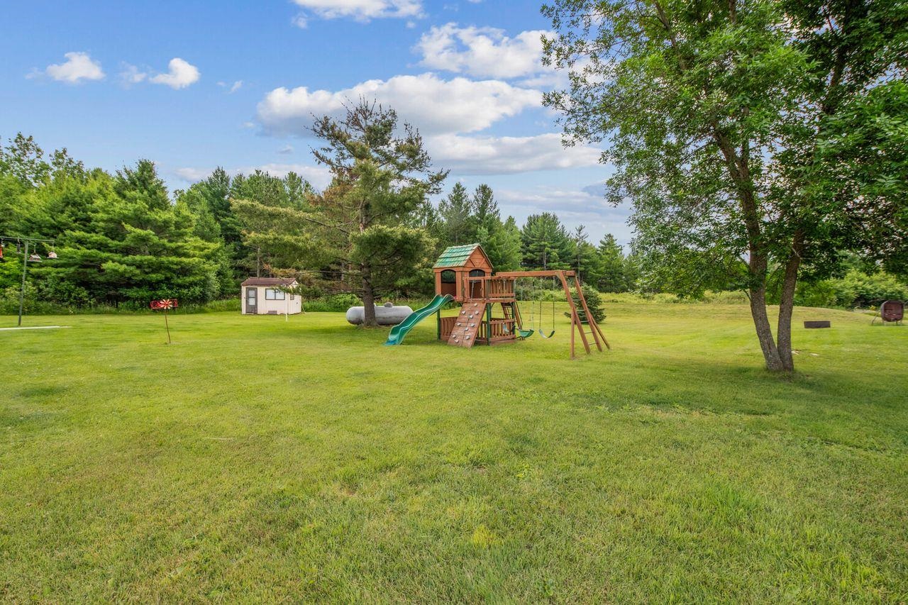 48424 Beaser Road Ashland, WI 54806 - Photo 26 of 30 View of grassy yard featuring a playground and a storage shed