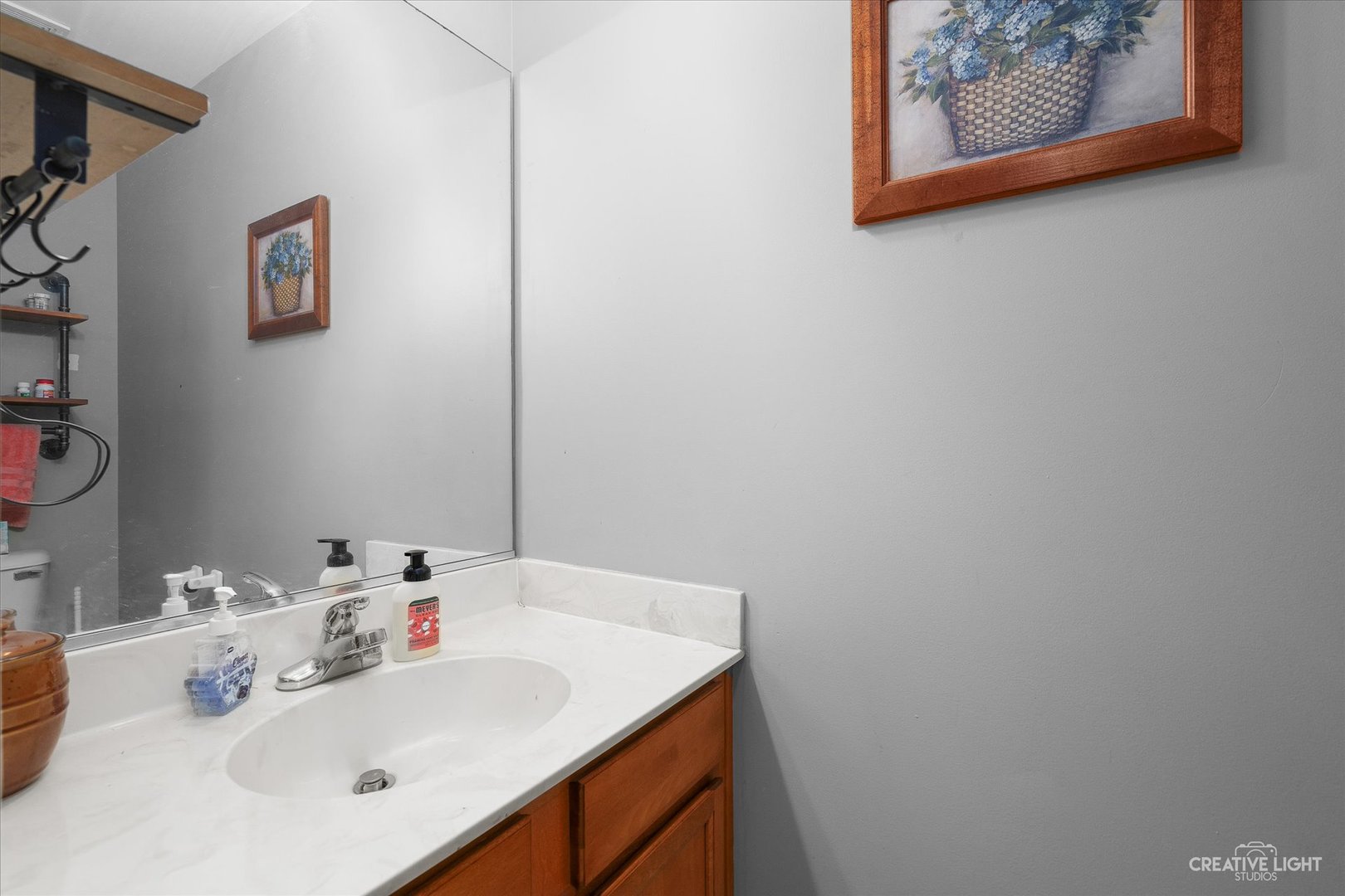 605 Ramsden Road Plano, IL 60545 - Photo 15 of 22 a bathroom with a sink and a mirror