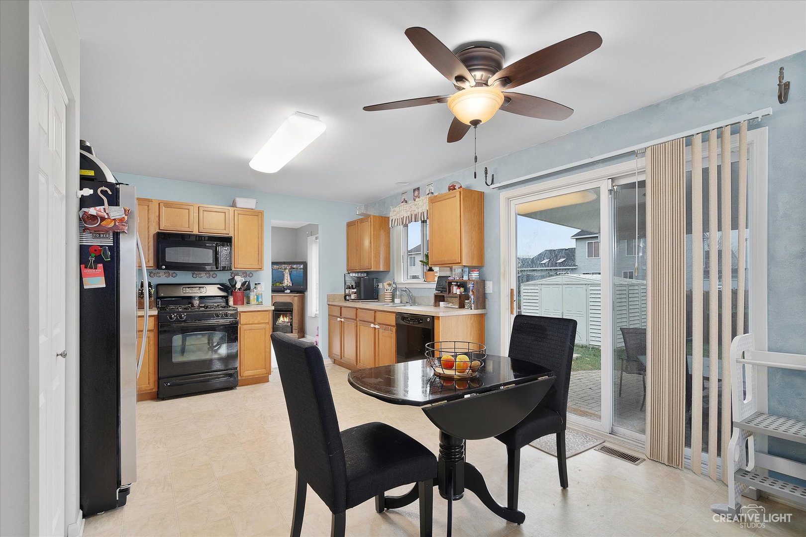 605 Ramsden Road Plano, IL 60545 - Photo 6 of 22 a dining room with furniture a flat screen tv and a large window