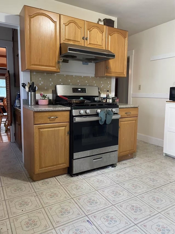 7 Granite Street, Unit 2 Cambridge, MA 02139 - Photo 23 of 31 a kitchen with stainless steel appliances granite countertop a stove a sink and a microwave