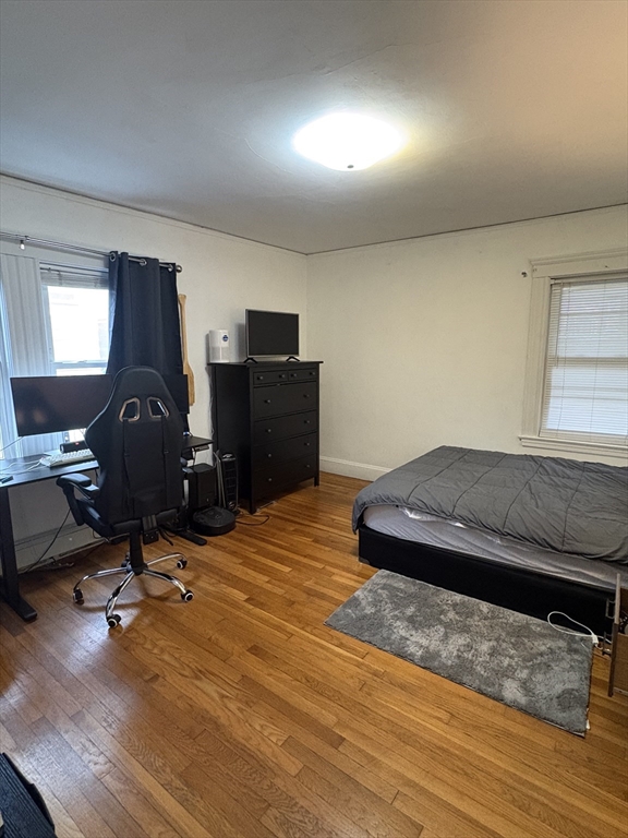 7 Granite Street, Unit 2 Cambridge, MA 02139 - Photo 28 of 31 a bedroom with a bed and wooden floor