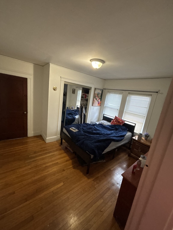 7 Granite Street, Unit 2 Cambridge, MA 02139 - Photo 29 of 31 a living room with a bed and wooden floor