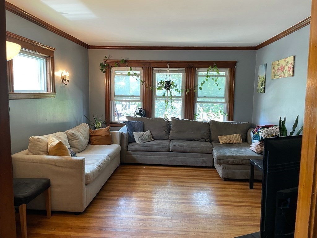 7 Granite Street, Unit 2 Cambridge, MA 02139 - Photo 9 of 31 a living room with furniture and a large window