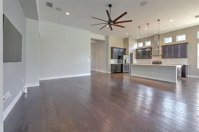 a bathroom with a granite countertop sink a toilet a mirror and shower
