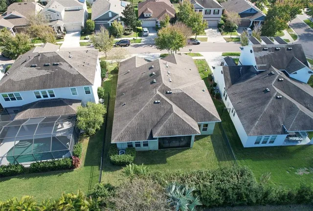 an aerial view of a house with a yard basket ball court and outdoor seating