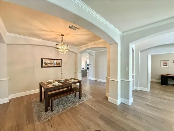 a view of a livingroom with wooden floor and furniture
