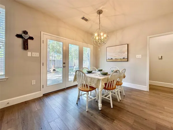 a view of a dining room with furniture window and wooden floor