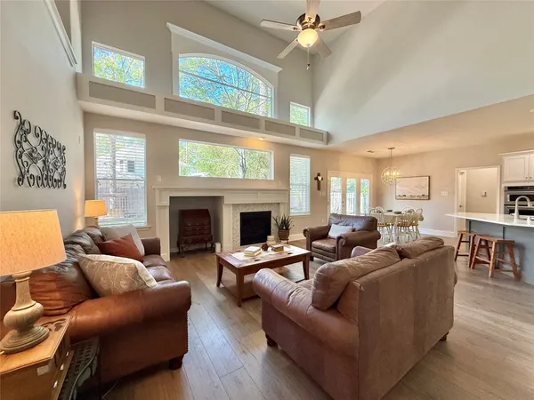 a living room with furniture fireplace and a large window