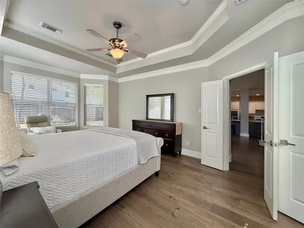 a bedroom with a large bed and a chandelier