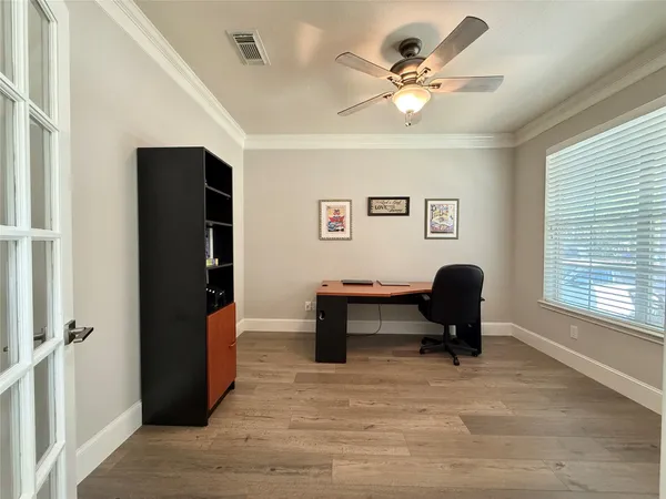 a living room with furniture piano and a window