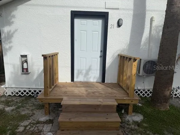 a living room with chairs and a table