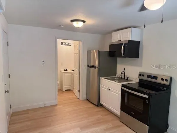 a kitchen with a stove and a refrigerator