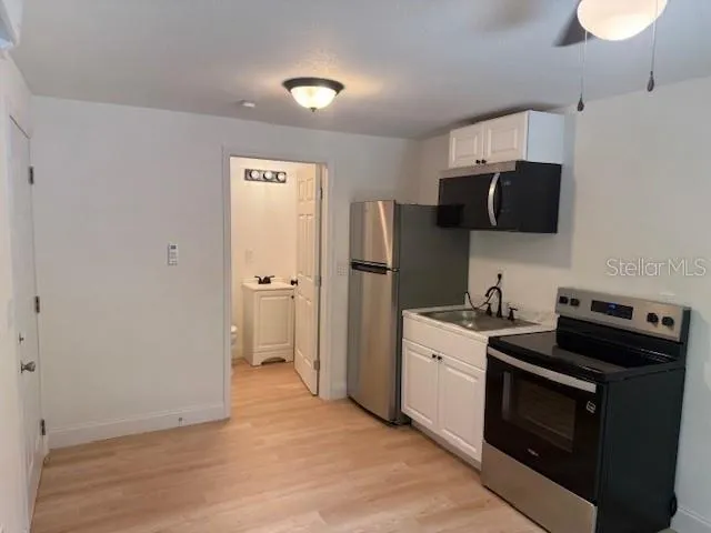 a kitchen with a stove and a refrigerator