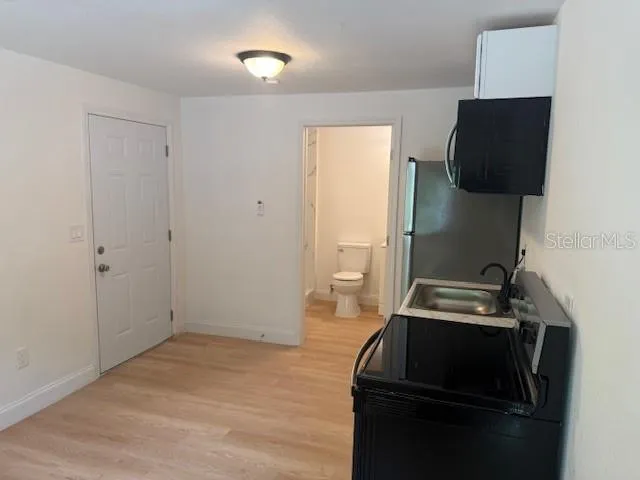 a kitchen with a stove and a refrigerator