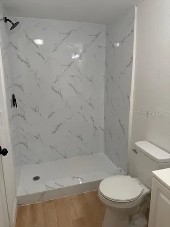 a bathroom with a toilet and a shower