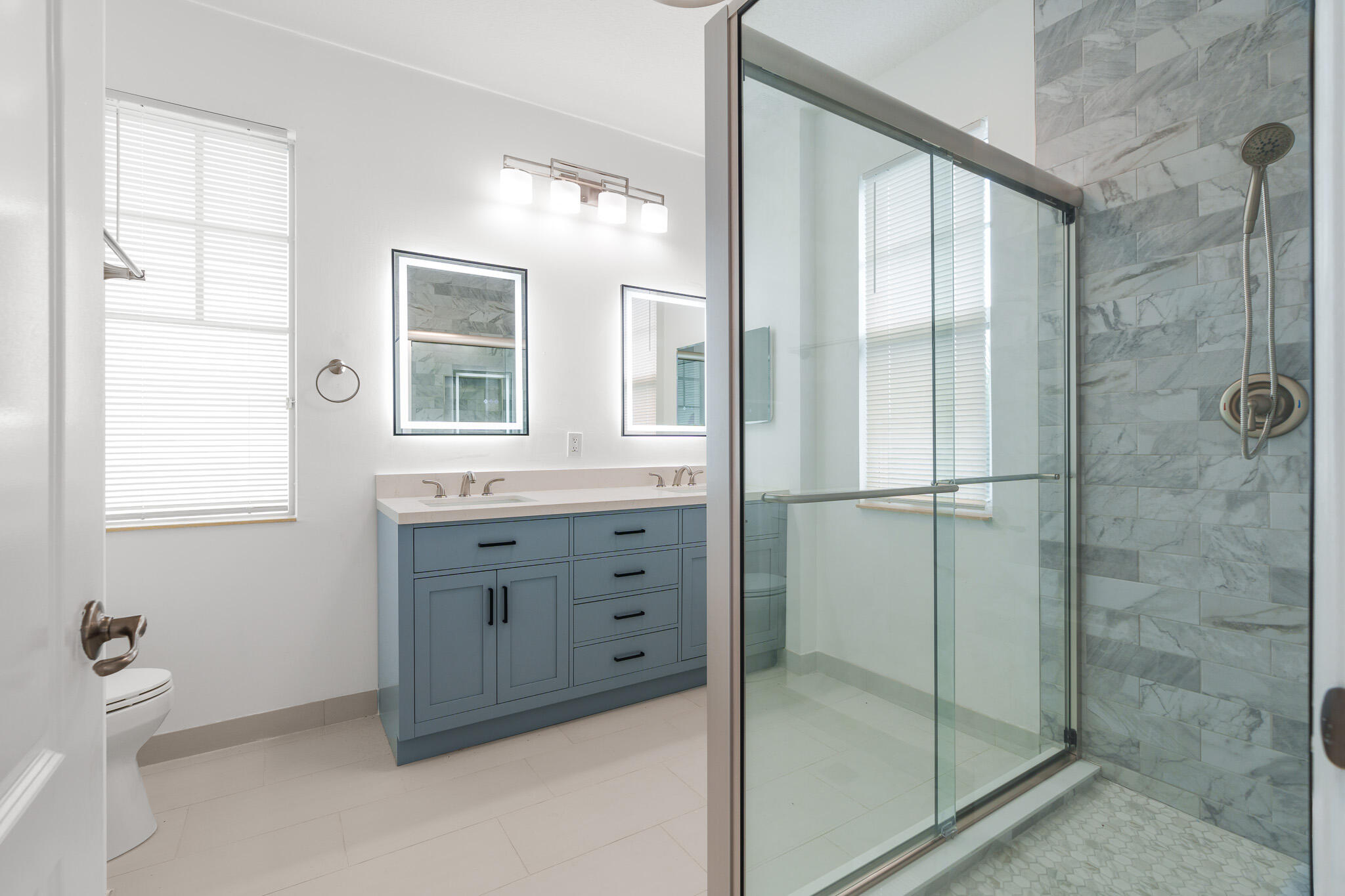 3830 Northwest 5th Terrace Boca Raton, FL 33431 - Photo 1 of 34 a bathroom with a shower sink and mirror