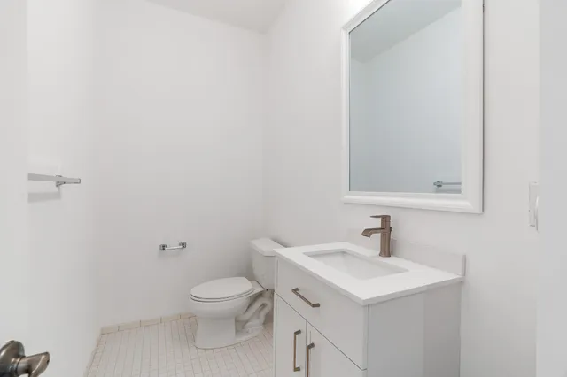 a bathroom with a sink a toilet and a mirror