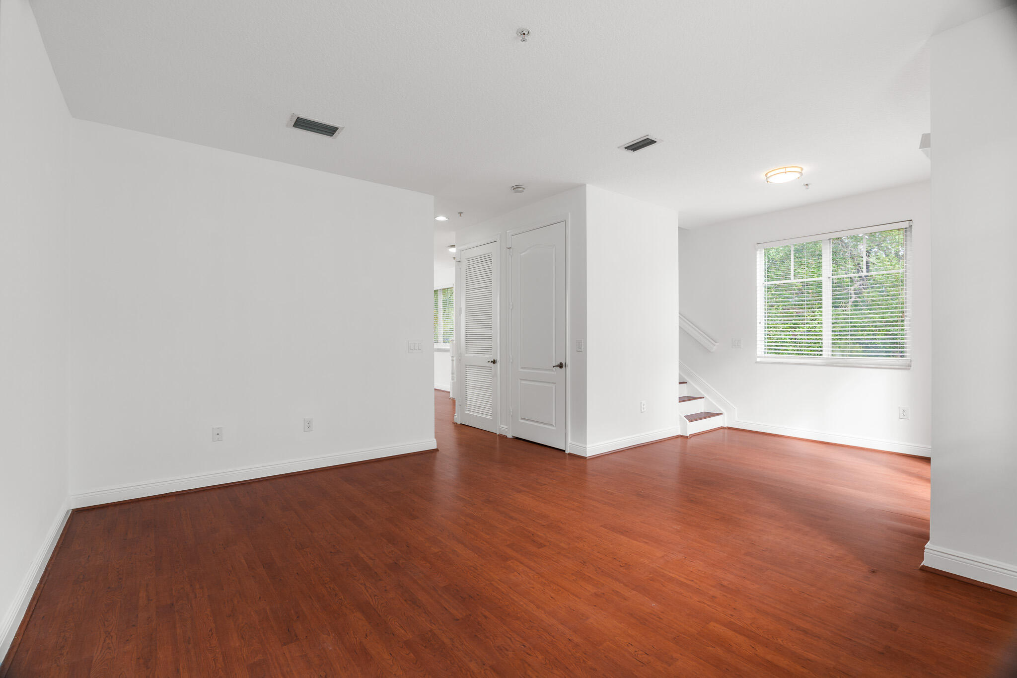 3830 Northwest 5th Terrace Boca Raton, FL 33431 - Photo 15 of 34 an empty room with wooden floor and windows