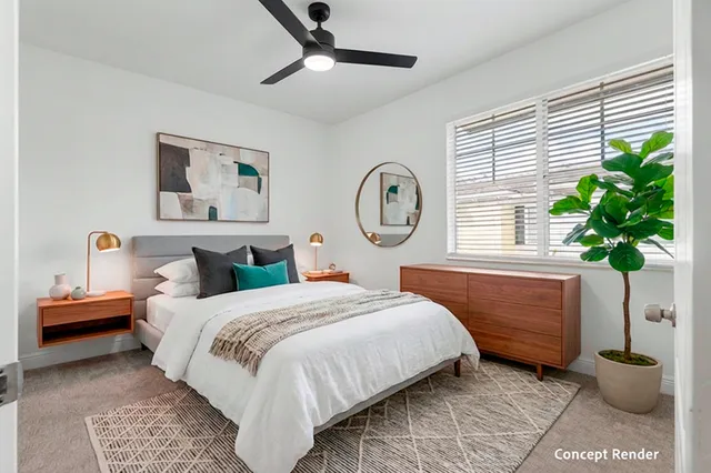 a bedroom with a bed a chandelier and a window