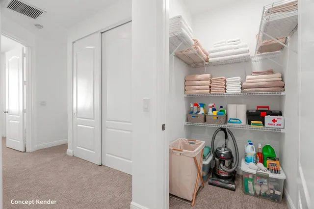 an empty room with chandelier fan and windows