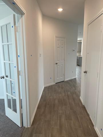 1509 Hope Rnch Road Leander, TX 78641 - Photo 4 of 25 Hallway featuring dark wood finished floors, baseboards, recessed lighting, and french doors