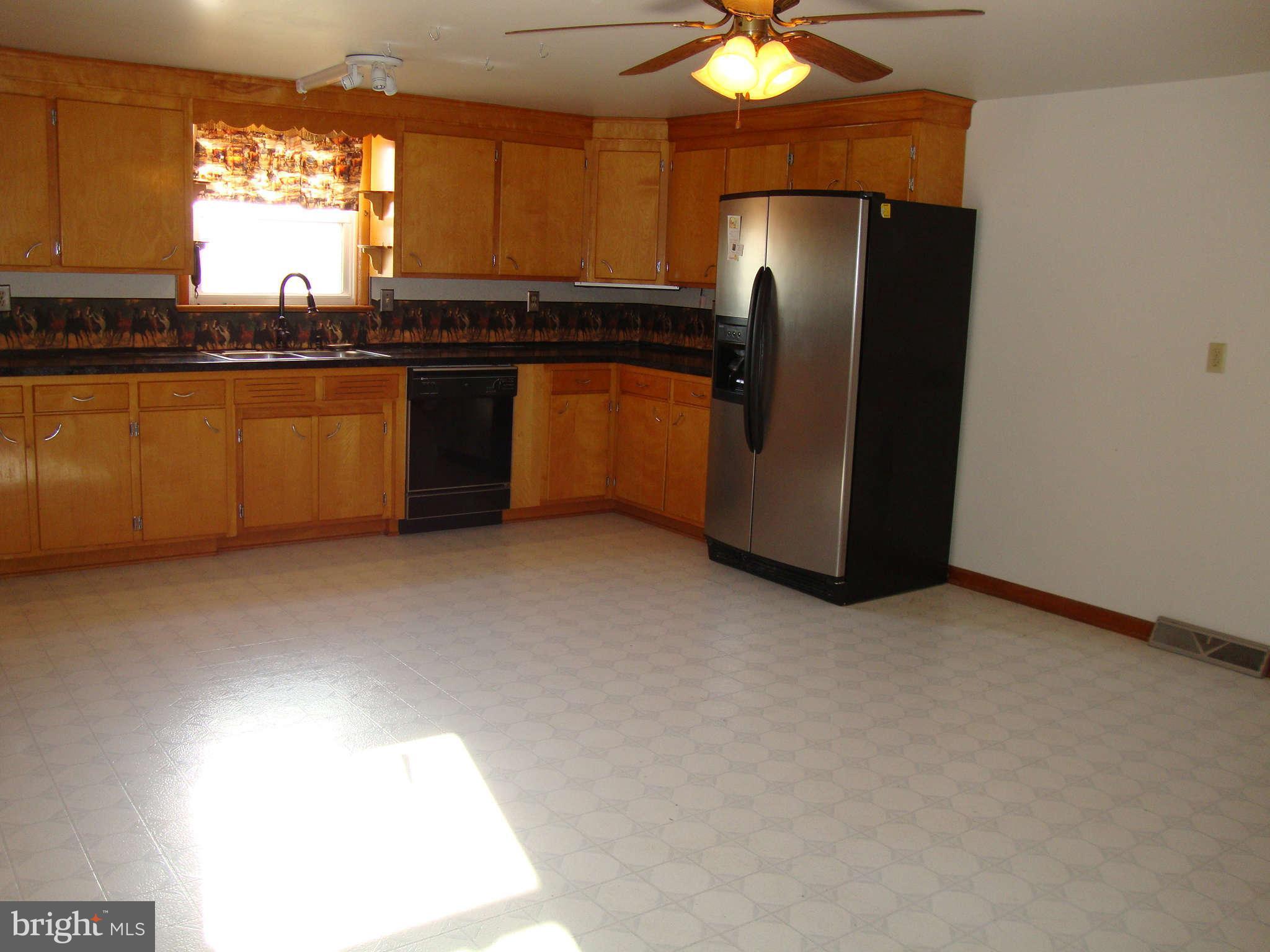 9709 Appolds Road Rocky Ridge, MD 21778 - Photo 7 of 13 a kitchen with stainless steel appliances granite countertop a refrigerator and a sink