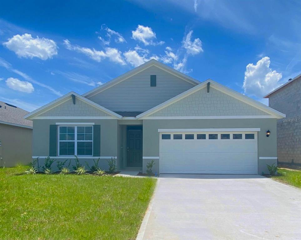 1747 Buckeye Road Davenport, FL 33837 - Photo 1 of 1 a front view of a house with a yard and garage