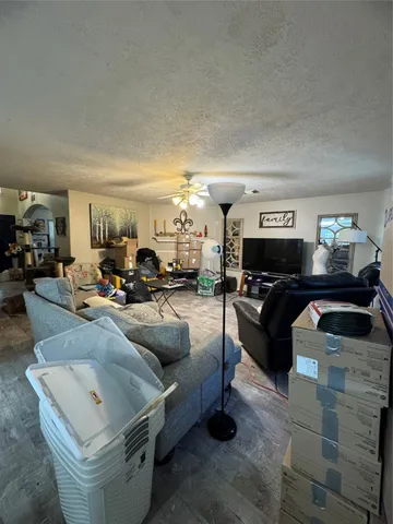 a living room with furniture and a mirror