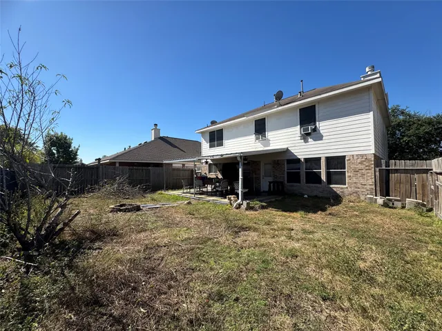 a view of a house with backyard and sitting area