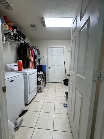 a view of a storage & utility room with two washing machine