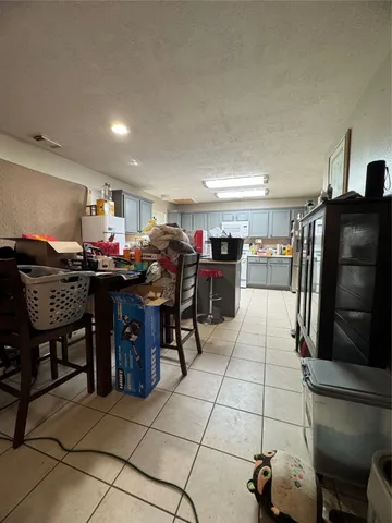 a open kitchen with stainless steel appliances granite countertop a table and chairs in it