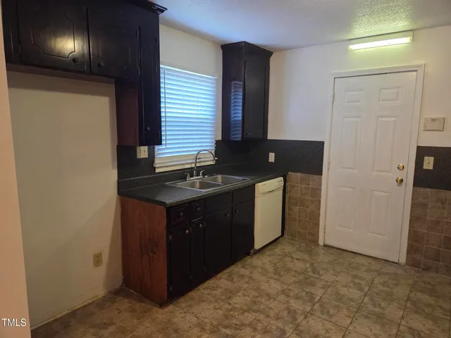 a kitchen with granite countertop cabinets and stove